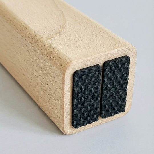 Close-up of non-slip rubber pads under the H-Tree feet for stable grip and floor protection.