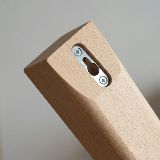 Close-up of keyhole wall-mounting slot on top of the H-Tree for secure attachment to the wall