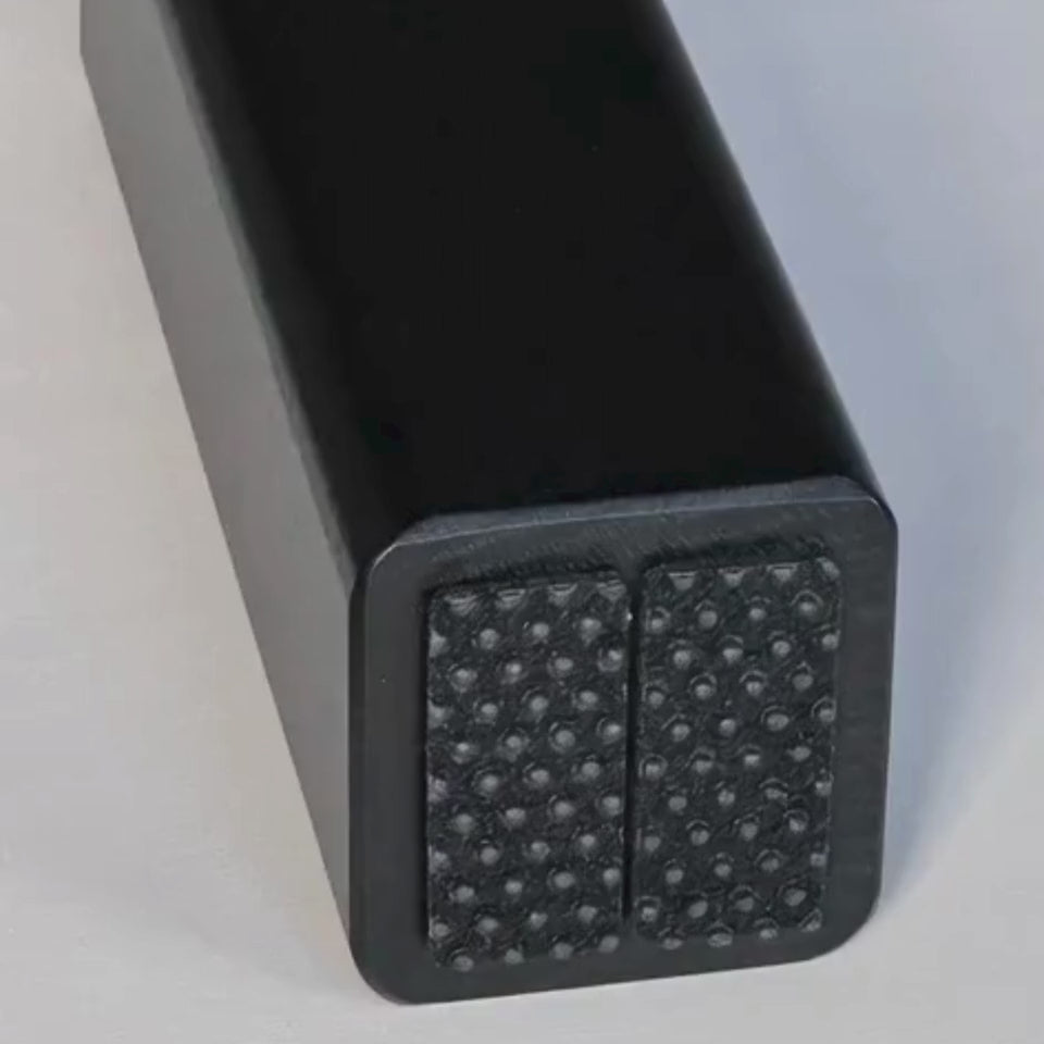 Close-up of non-slip rubber pads under the H-Tree feet for stable grip and floor protection.