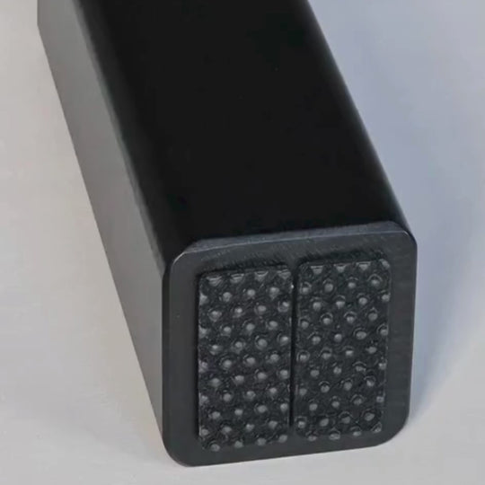 Close-up of non-slip rubber pads under the H-Tree feet for stable grip and floor protection.